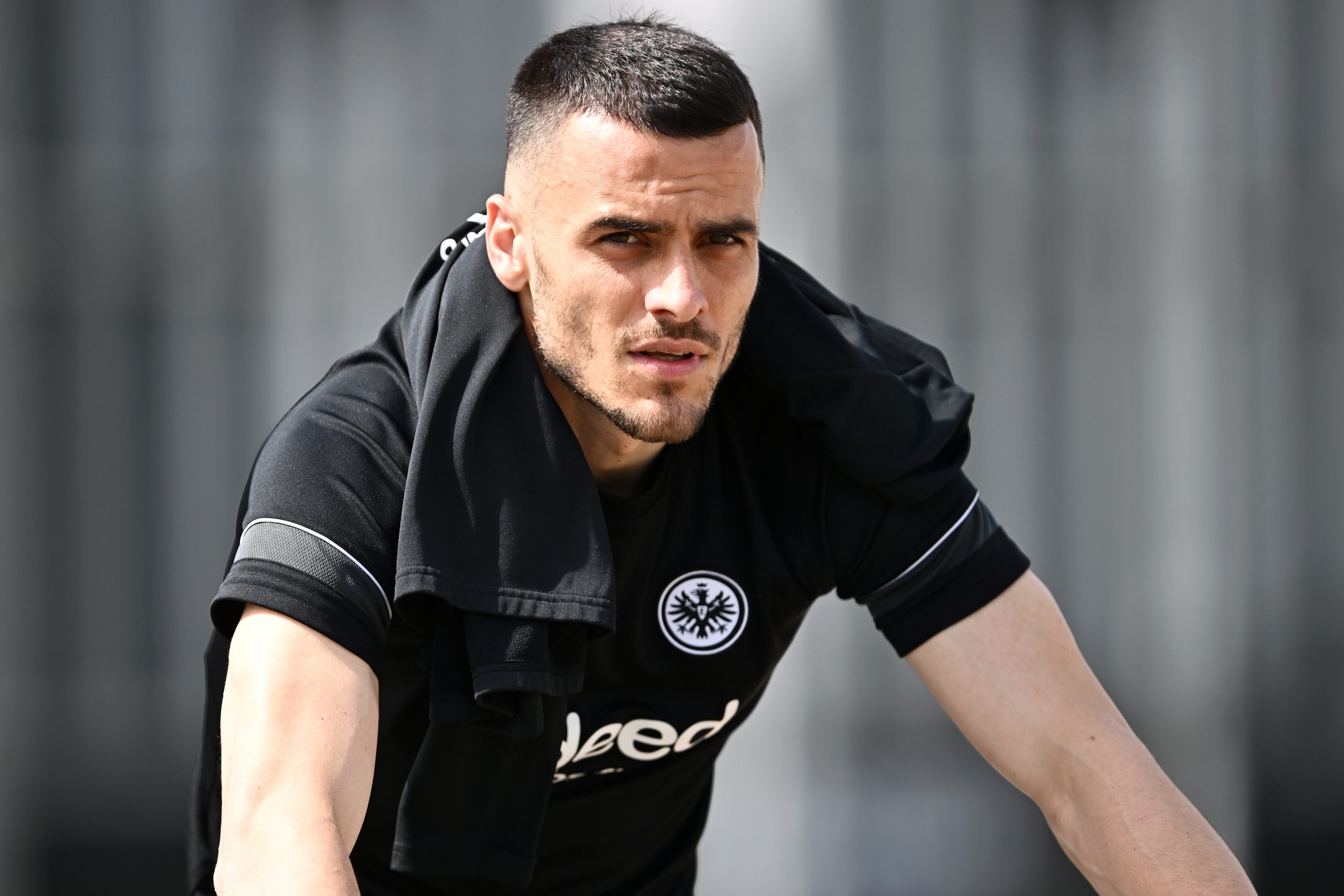 FRANKFURT AM MAIN, GERMANY - MAY 17: Filip Kostic of Eintracht Frankfurt arrives on a bicycle prior to a Eintracht Frankfurt Training Session at Deutsche Bank Park on May 17, 2022 in Frankfurt am Main, Germany. Eintracht Frankfurt will face Rangers FC in the UEFA Europa League final on May 18, 2022. (Photo by Alexander Scheuber/Getty Images)