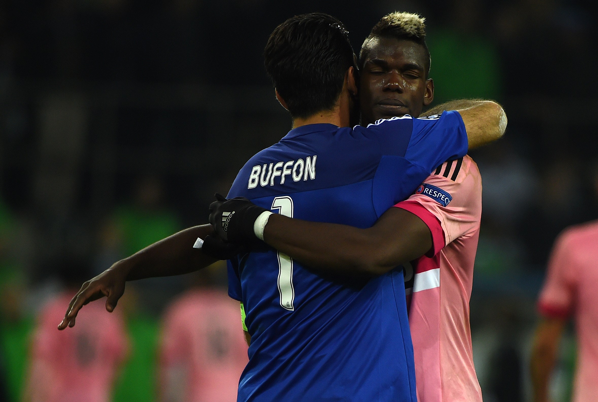 Juventus' goalkeeper Gianluigi Buffon and French midfielder Paul Pogba embrace after the UEFA Champions League Group D, second-leg football match Borussia Moenchengladbach vs Juventus in Moenchengladbach, western Germany on November 3, 2015. The match ended with a 1-1 draw. AFP PHOTO / PATRIK STOLLARZ (Photo credit should read PATRIK STOLLARZ/AFP via Getty Images)