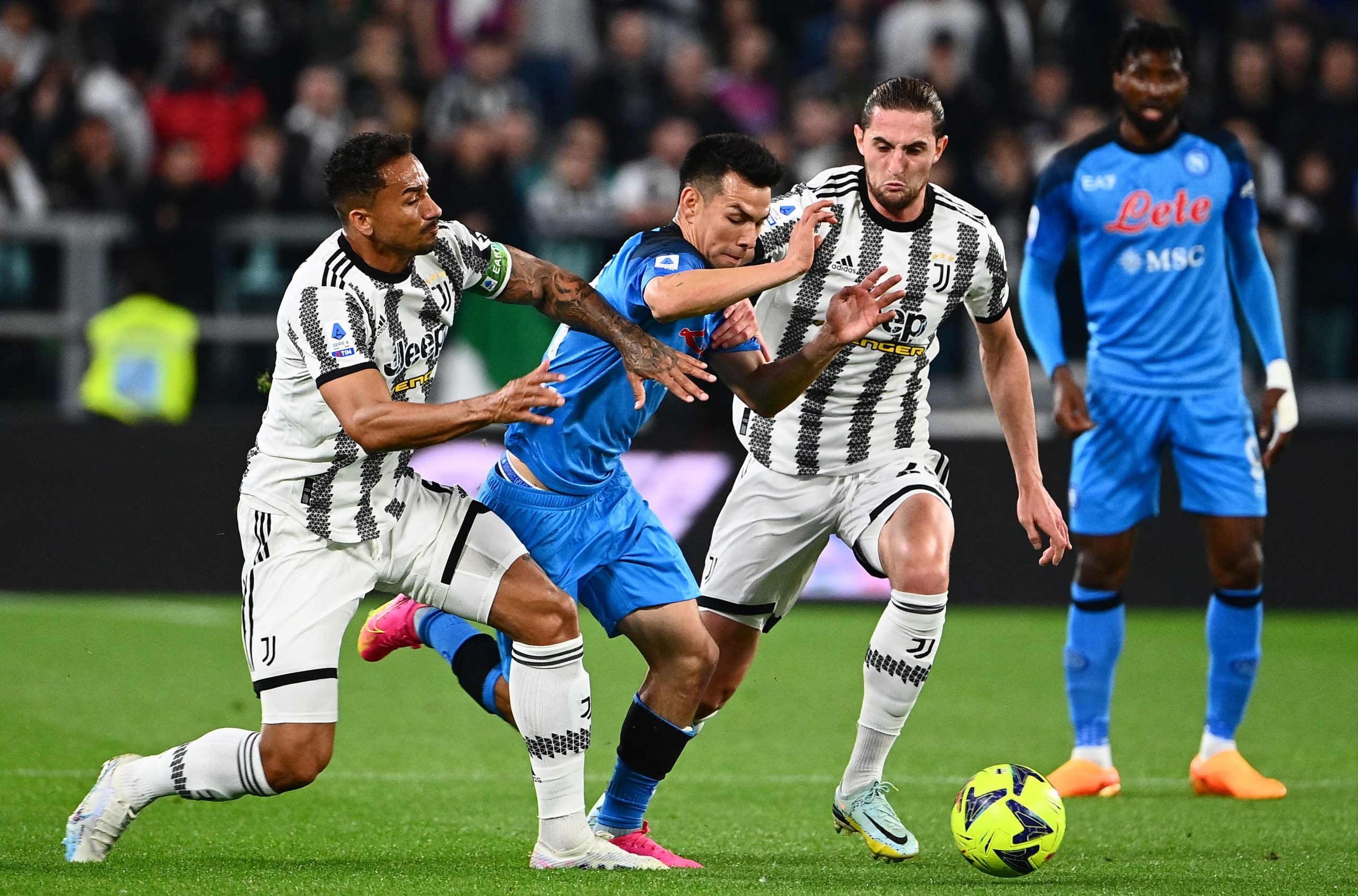 Napoli's Mexican forward Hirving Lozano (C) fights for the ball with Juventus' French midfielder Adrien Rabiot (L) and Juventus' Brazilian defender Danilo during the Italian Serie A football match between Juventus and Napoli on April 23, 2023 at the Juventus stadium in Turin. (Photo by Isabella BONOTTO / AFP) (Photo by ISABELLA BONOTTO/AFP via Getty Images)