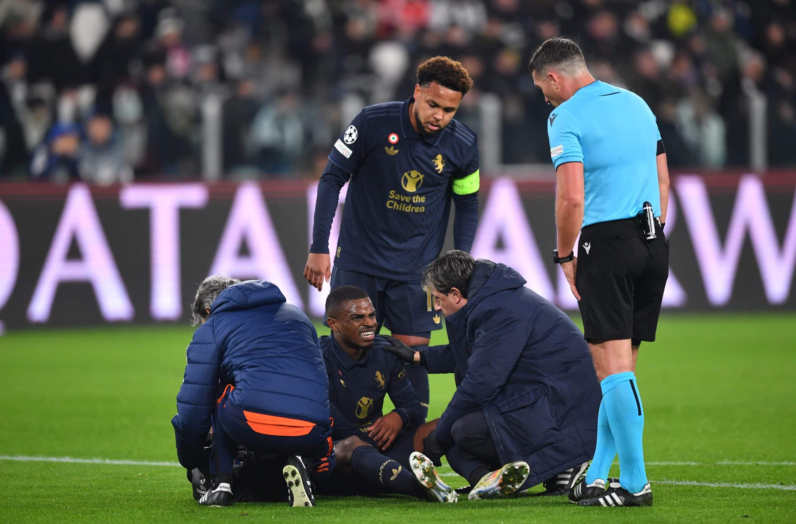 TURIN, ITALY - JANUARY 29: Pierre Kalulu of Juventus receives medical treatment during the UEFA Champions League 2024/25 League Phase MD8 match between Juventus and SL Benfica at Juventus Stadium on January 29, 2025 in Turin, Italy. (Photo by Valerio Pennicino/Getty Images)